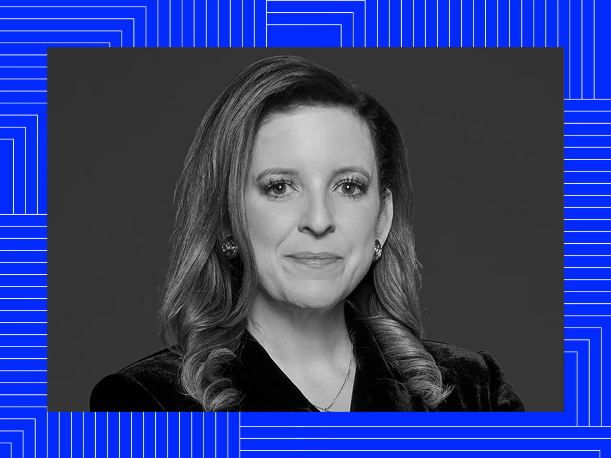 Black-and-white portrait of Melanie over a blue patterned frame